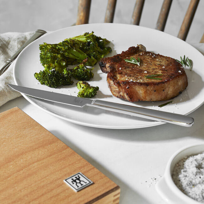 Zwilling J A Henckels Stainless Steel Steak Knife Set with Wood Presentation Case, 8-pc - knife on plate