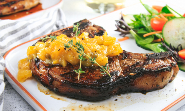 Marinated Bone-in Pork Chops on the Grill with a Spicy Peach Sauce